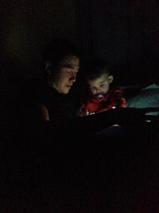 Jeff and Jack reading books by flashlight.